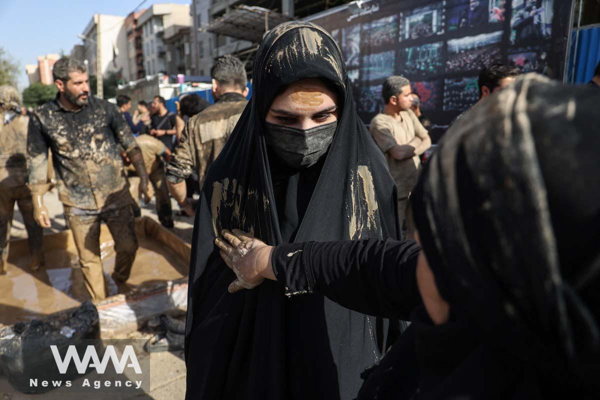 Iranian Shi'ite Muslims mourn after covering themselves with mud during a ceremony to mark Ashura, the holiest day on the Shi'ite Muslim calendar, in Tehran, Iran July 28, 2023. Majid Asgaripour/WANA (West Asia News Agency)