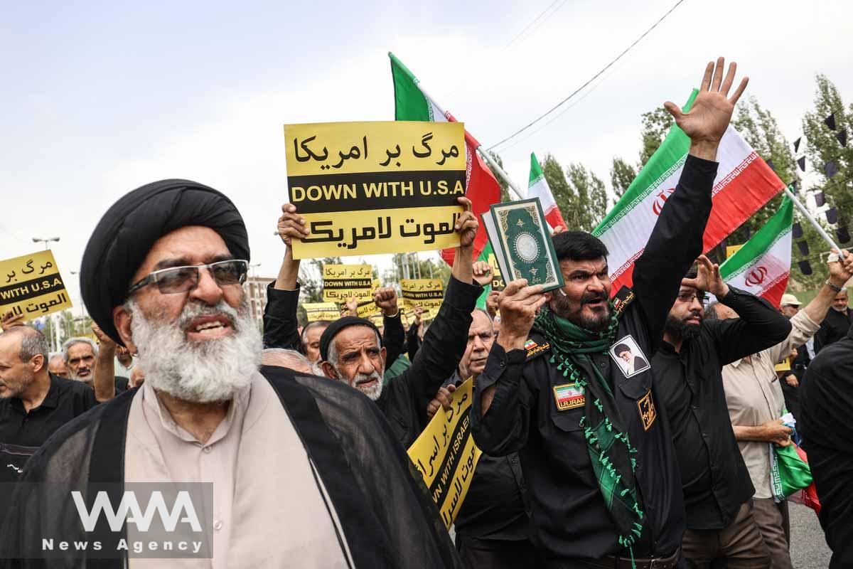 An Iranian protester holds the Koran in his hand, during a protest against the insult to the Koran in Stockholm, in Tehran, Iran July 21, 2023. Majid Asgaripour/WANA (West Asia News Agency)