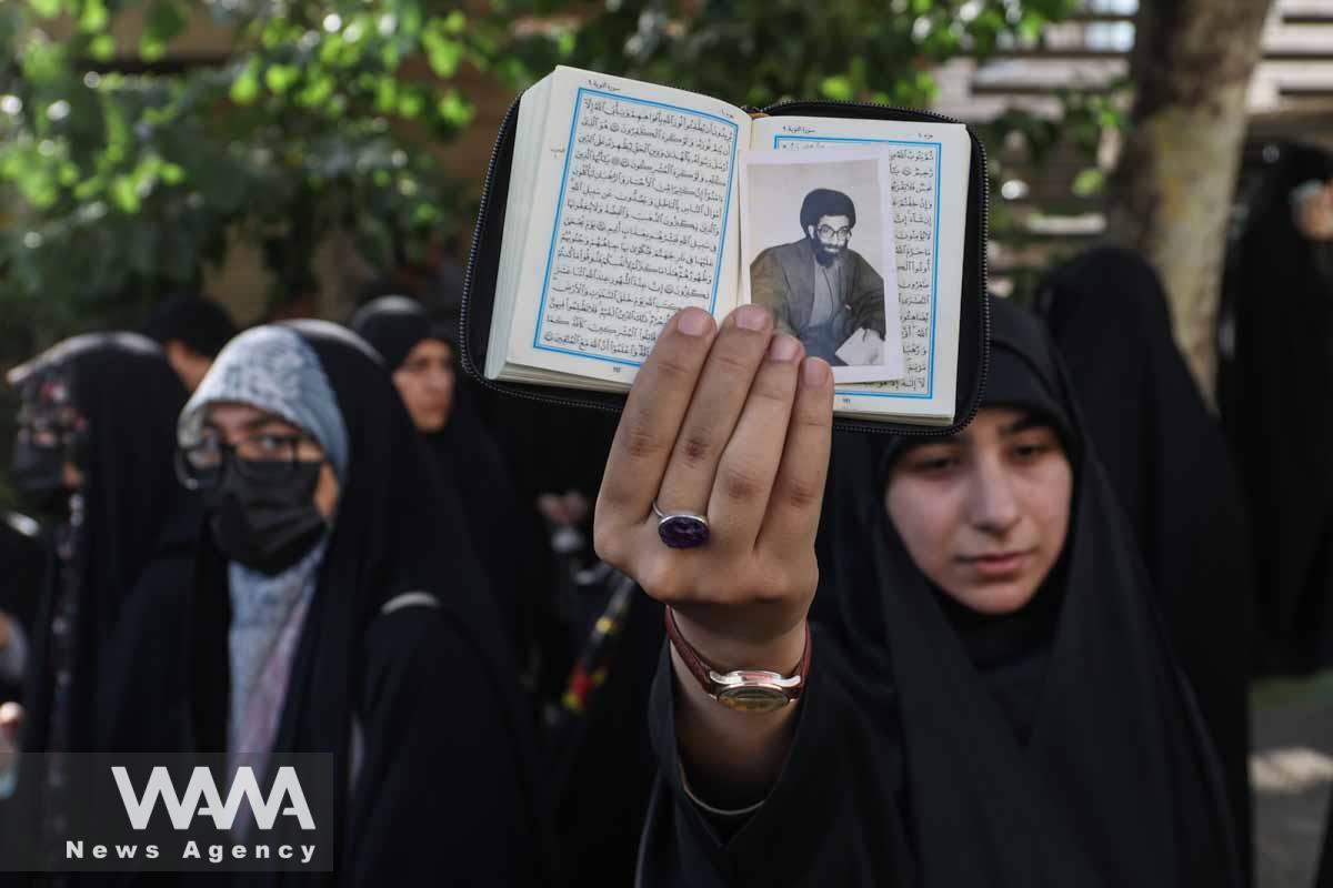 An Iranian protester holds the Koran in her hand during a protest against the insult to the Koran in Stockholm, in front of the Swedish Embassy in Tehran, Iran July 21, 2023. Majid Asgaripour/WANA (West Asia News Agency)