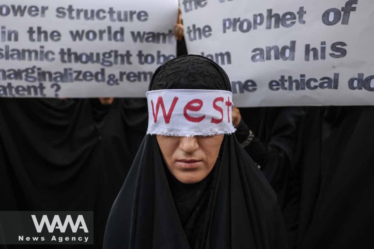 A female protester covers her eyes with a blindfold that says West during a protest against the insult to the Koran in Stockholm, in front of the Swedish Embassy in Tehran, Iran July 21, 2023. Majid Asgaripour/WANA (West Asia News Agency)