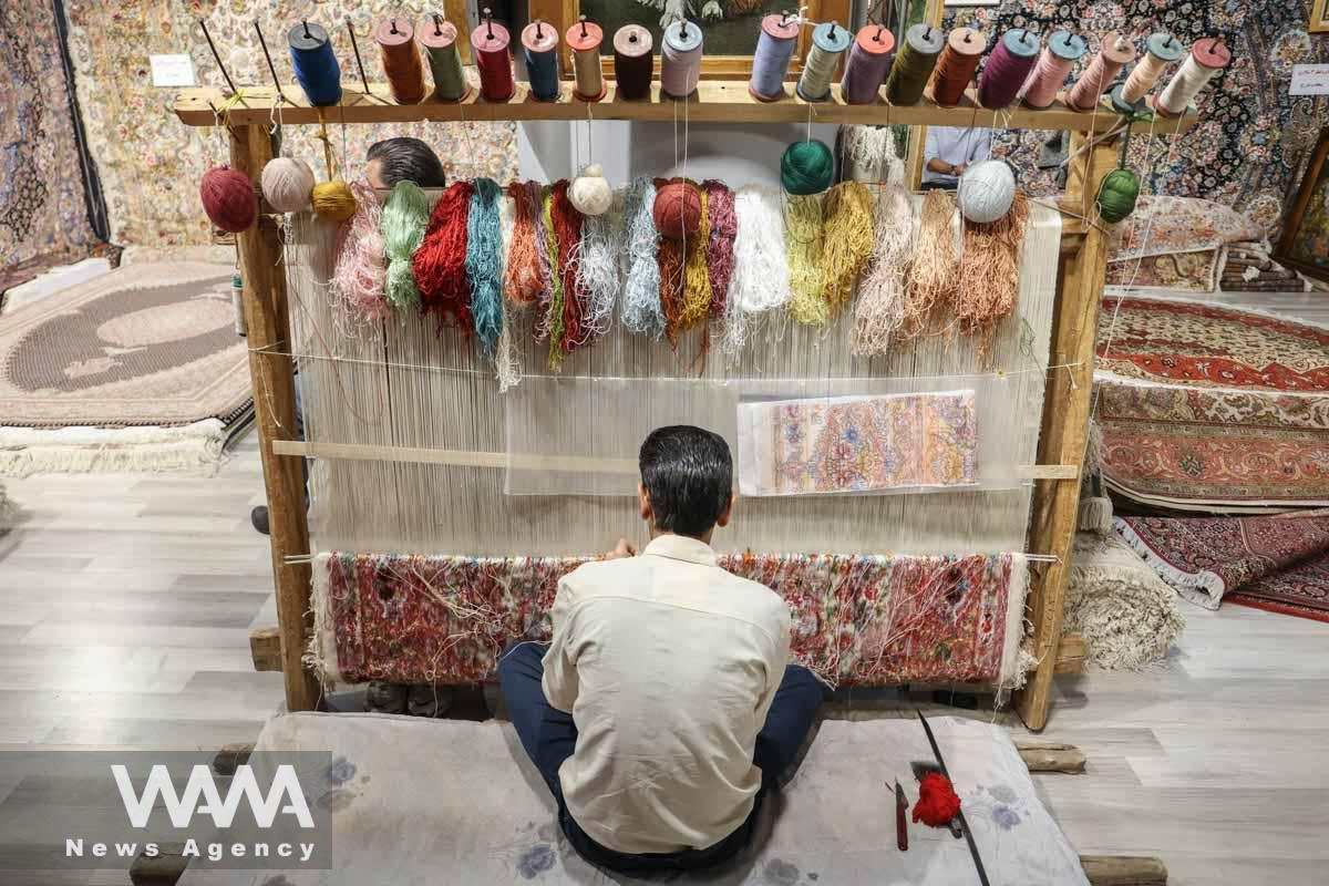 An Iranian man weaves a carpet during the 30th Handmade Carpet Exhibition in Tehran, Iran August 26, 2023. Majid Asgaripour/WANA (West Asia News Agency)
