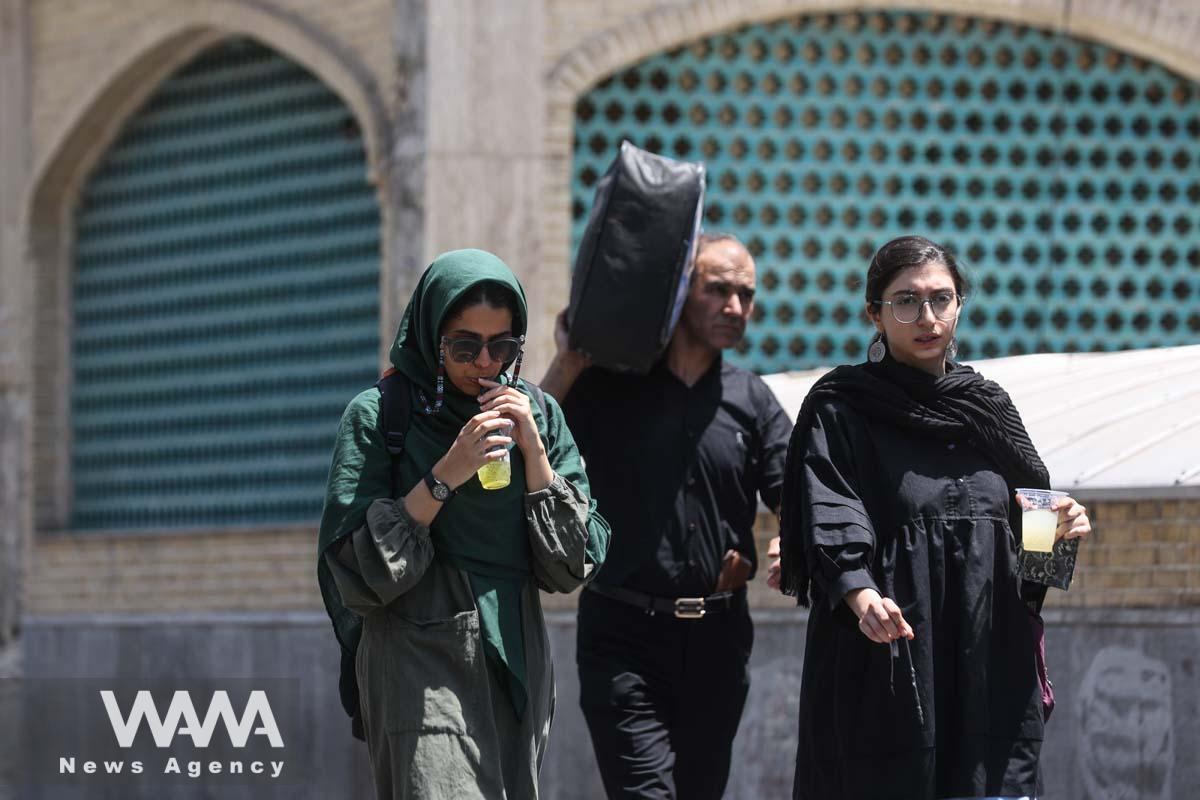 Iranians drink cold drinks during the heat surge in Tehran, Iran August 2, 2023. Majid Asgaripour/WANA (West Asia News Agency)