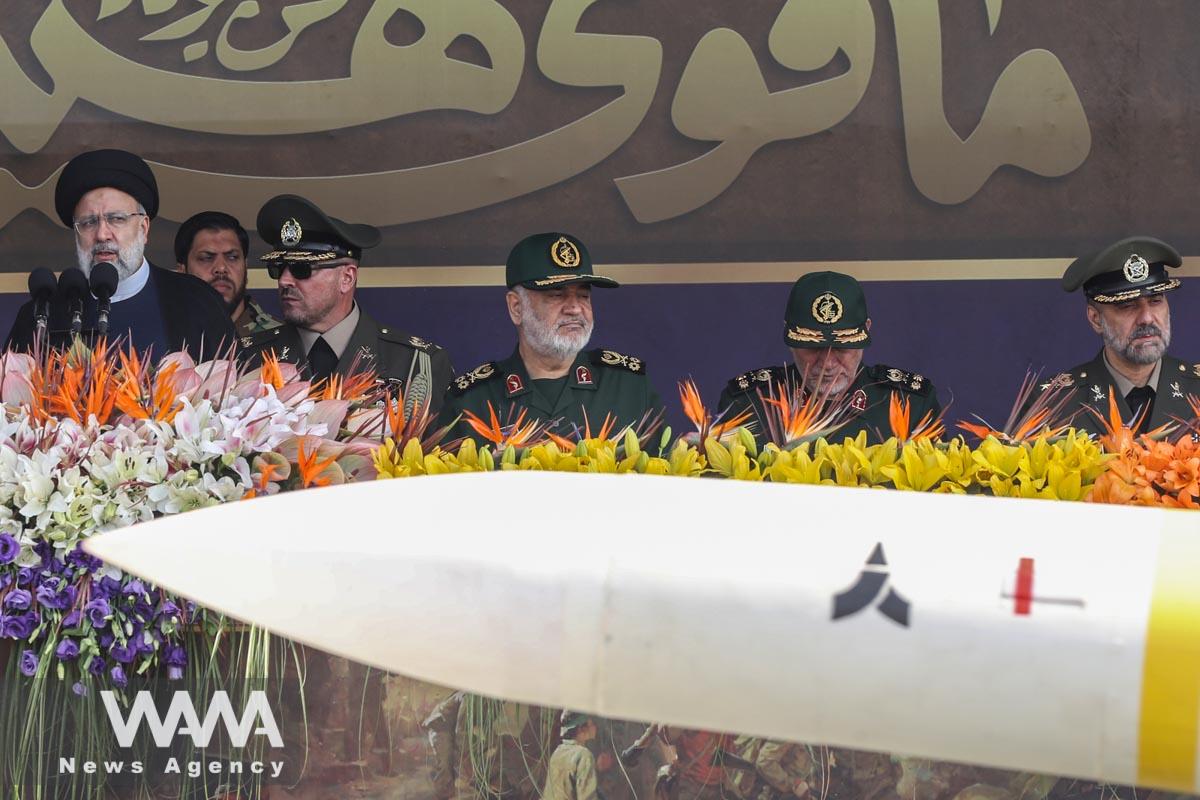 Iranian President Ebrahim Raisi and military commanders watch as military equipment passes by during the annual military parade in Tehran, Iran, September 22, 2023. Majid Asgaripour/WANA (West Asia News Agency)