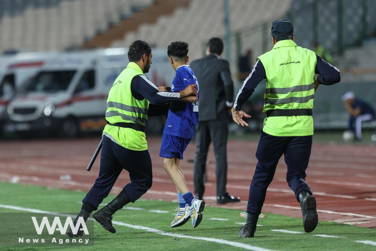 Soccer Football - Asian Champions League - Group D - Nassaji Mazandaran v Al Hilal - Azadi Stadium, Tehhran, Iran - October 3, 2023 Young Al Hilal pitch invader is detained by stewards Majid Asgaripour/WANA (West Asia News Agency)