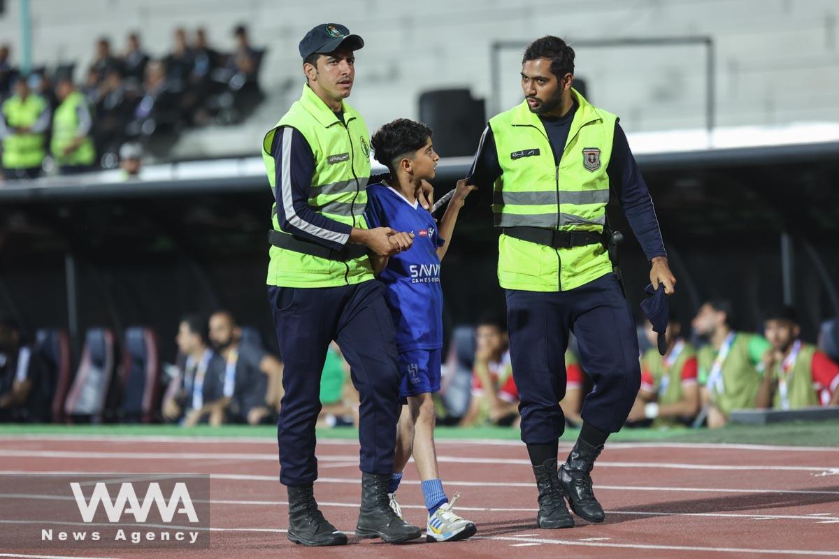 Soccer Football - Asian Champions League - Group D - Nassaji Mazandaran v Al Hilal - Azadi Stadium, Tehhran, Iran - October 3, 2023 Young Al Hilal pitch invader is detained by stewards Majid Asgaripour/WANA (West Asia News Agency)