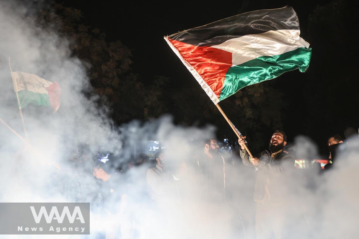 Iranian celebrate during a gathering in support of Palestinians, in Tehran, Iran, October 7, 2023. Majid Asgaripour/WANA (West Asia News Agency)