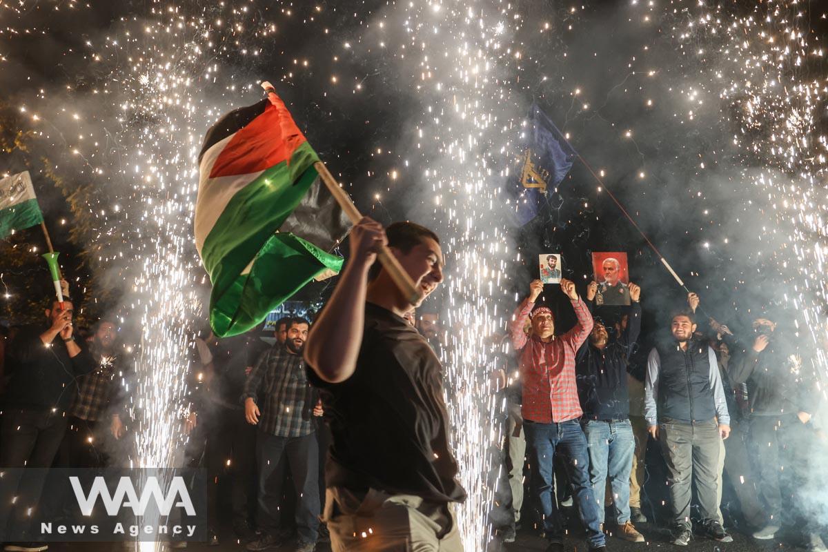 Iranian celebrate during a gathering in support of Palestinians, in Tehran, Iran, October 7, 2023. Majid Asgaripour/WANA (West Asia News Agency)