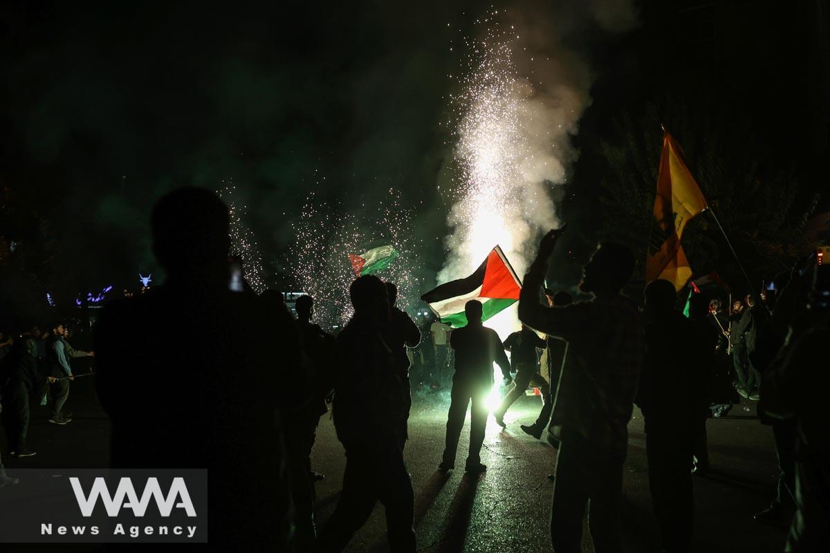 Iranian celebrate during a gathering in support of Palestinians, in Tehran, Iran, October 7, 2023. Majid Asgaripour/WANA (West Asia News Agency)