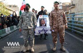 Members of Basij paramilitary forces hold a coffin with a picture of Israeli Prime Minister Benjamin Netanyahu on it during an anti-Israel rally in Tehran/WANA (West Asia News Agency)