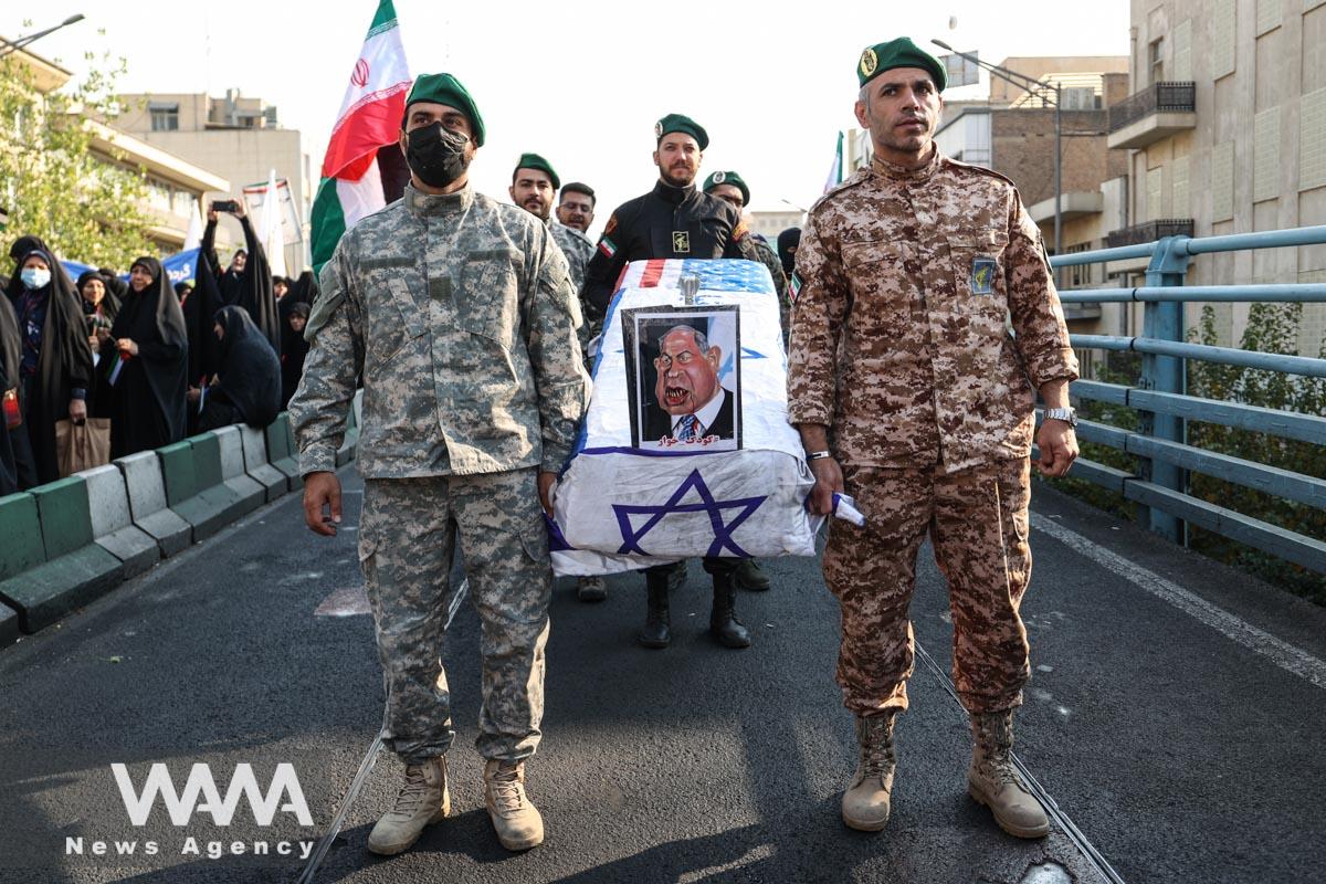 Members of Basij paramilitary forces hold a coffin with a picture of Israeli Prime Minister Benjamin Netanyahu on it during an anti-Israel rally in Tehran/WANA (West Asia News Agency)