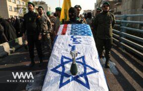 Members of Basij paramilitary forces hold a coffin with the Israeli flag during an anti-Israel rally in Tehran/WANA (West Asia News Agency)