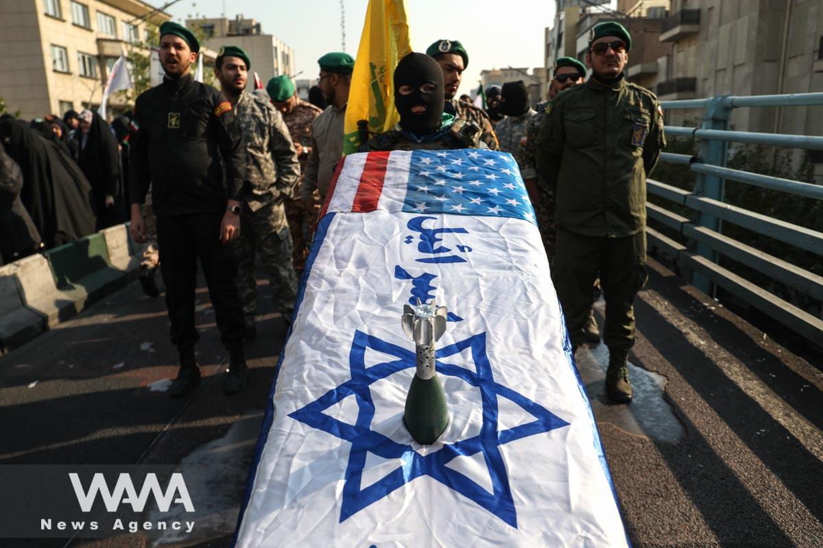 Members of Basij paramilitary forces hold a coffin with the Israeli flag during an anti-Israel rally in Tehran/WANA (West Asia News Agency)