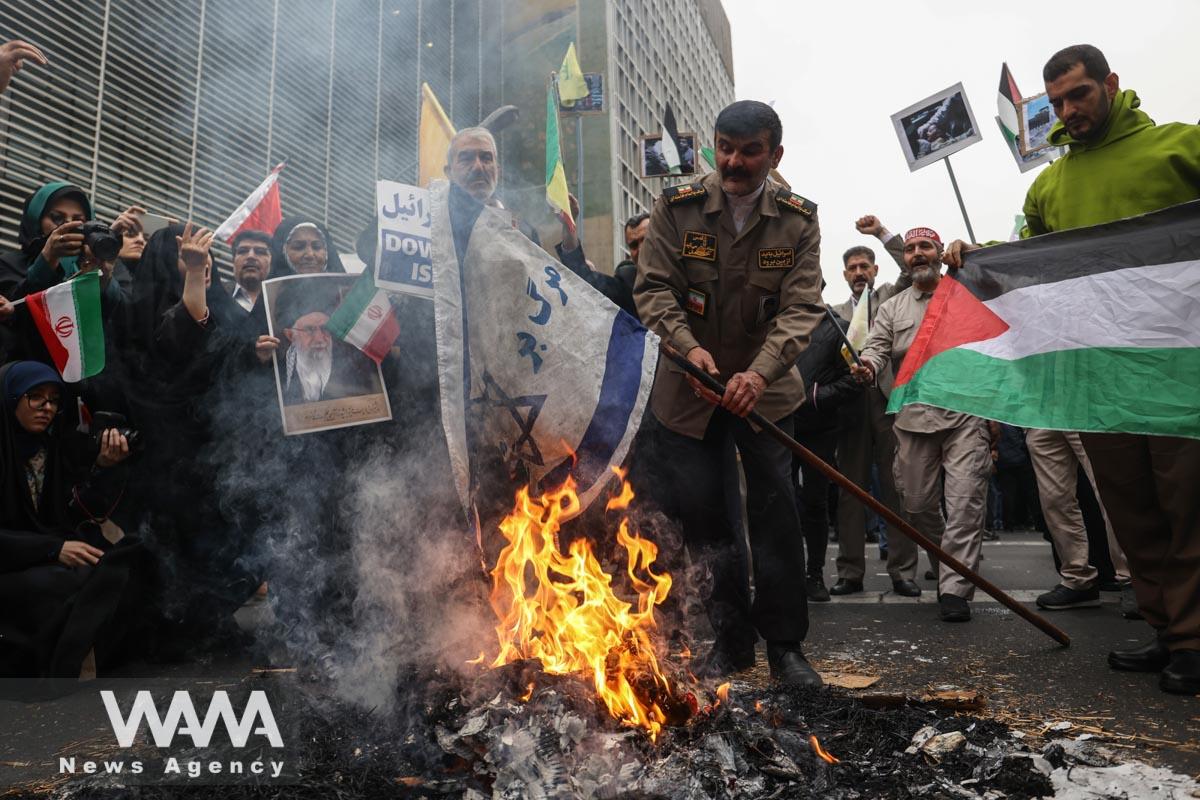 An Iranian man burns an Israeli flag during the 44th anniversary of the U.S. expulsion from Iran/WANA (West Asia News Agency)