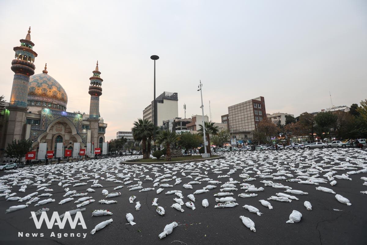 Symbolic shrouds of Gaza children's dead bodies are seen during a gesture in a street in Tehran/WANA (West Asia News Agency)