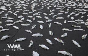 Symbolic shrouds of Gaza children's dead bodies are seen during a gesture in a street in Tehran/WANA (West Asia News Agency)