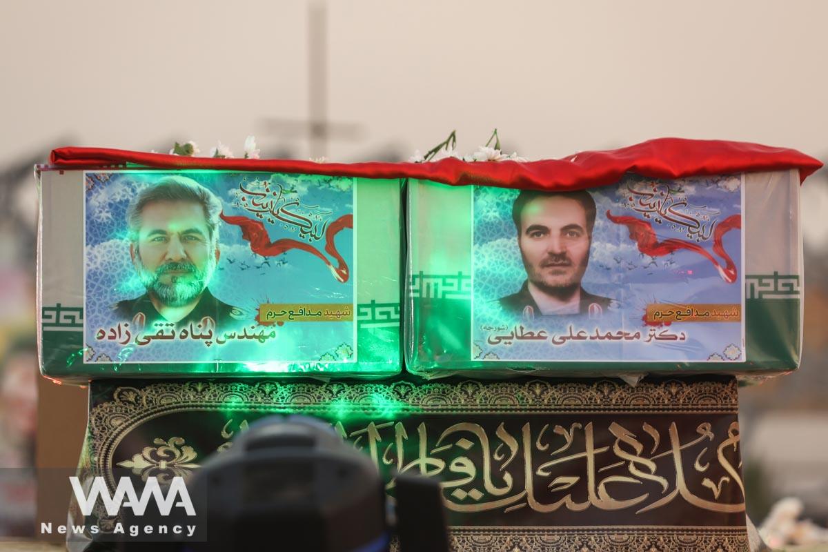 The picture of Panah Taghizadeh and Mohammad-Ali Ataie, members of Iran's Islamic Revolution Guards Corps (IRGC) who were killed in an Israeli airstrike on Syria, is seen on their coffins during their funeral held/WANA (West Asia News Agency)