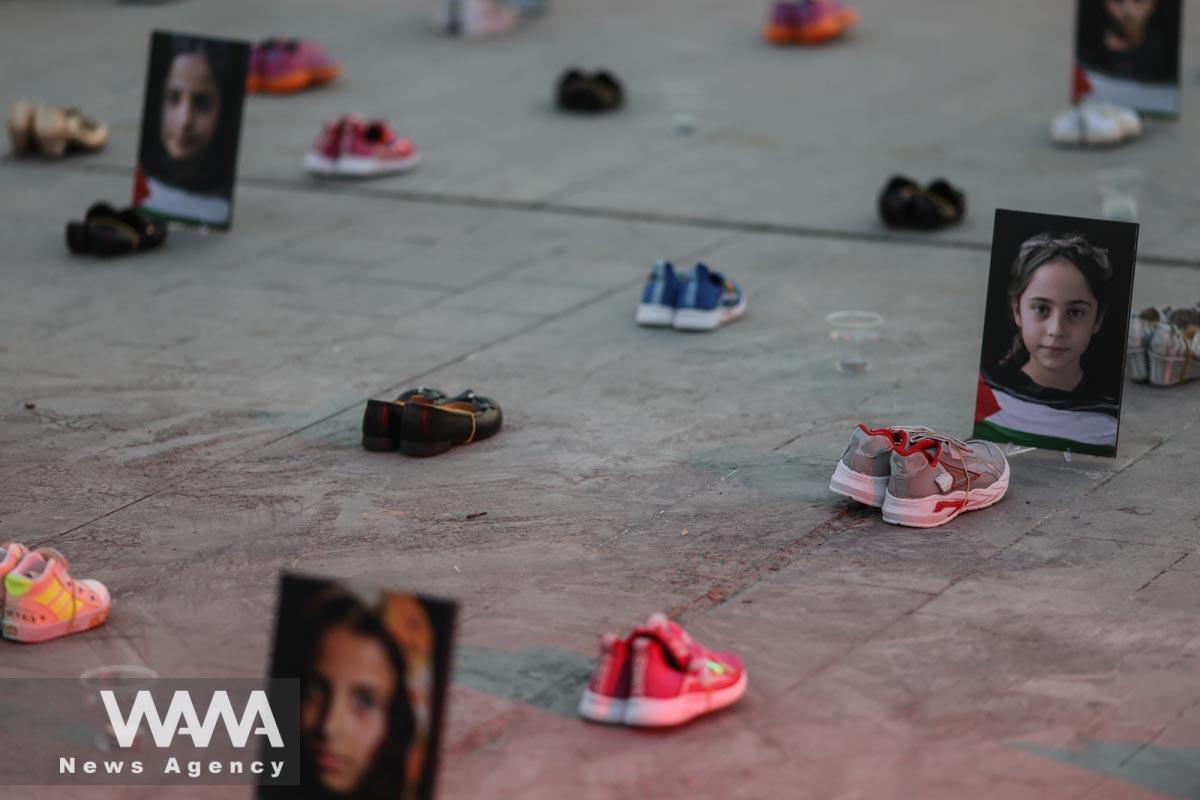Symbolic shoes and pictures depicting deceased children in Gaza on display during a pro-Palestine campaign//WANA (West Asia News Agency)