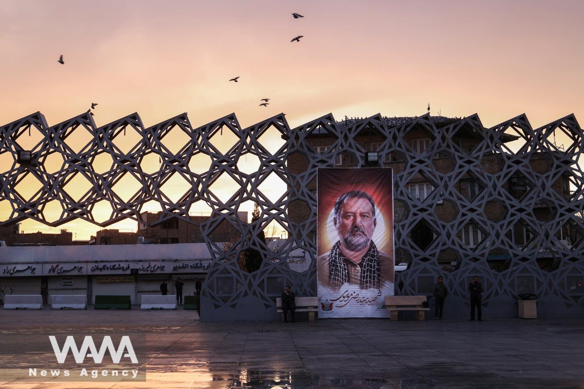 A billboard with a picture of the late senior adviser for Iran's Revolutionary Guards, Sayyed Razi Mousavi, who was killed by an Israeli airstrike in Syria, is displayed during his funeral