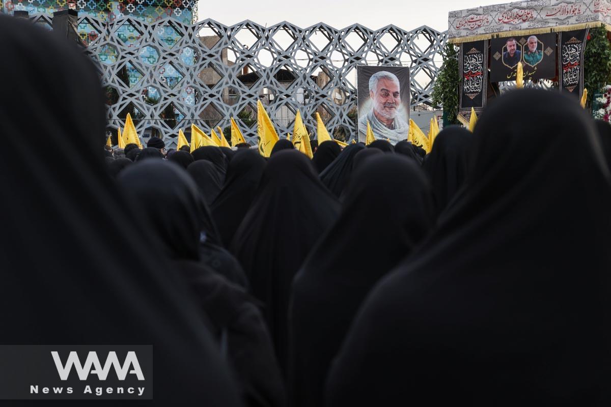 A billboard with a picture of the late Iranian Major-General Qasem Soleimani is displayed during a funeral of the late senior adviser for Iran's Revolutionary Guards, Sayyed Razi Mousavi, who was killed by an Israeli airstrike in Syria