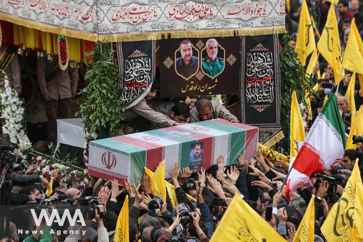 People carry the coffin of senior adviser for Iran's Revolutionary Guards, Sayyed Razi Mousavi, who was killed in an Israeli air strike outside the Syrian capital Damascus, during his funeral