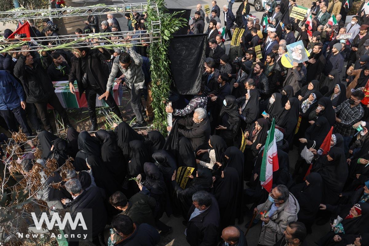 People attend the funeral ceremony of Faezeh Rahimi one of the casualties of the ISIS attack in Kerman, after Friday prayers