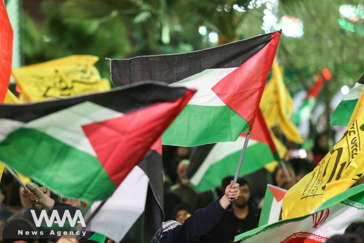 Protesters hold Palestinian flags during an anti-Israel protest