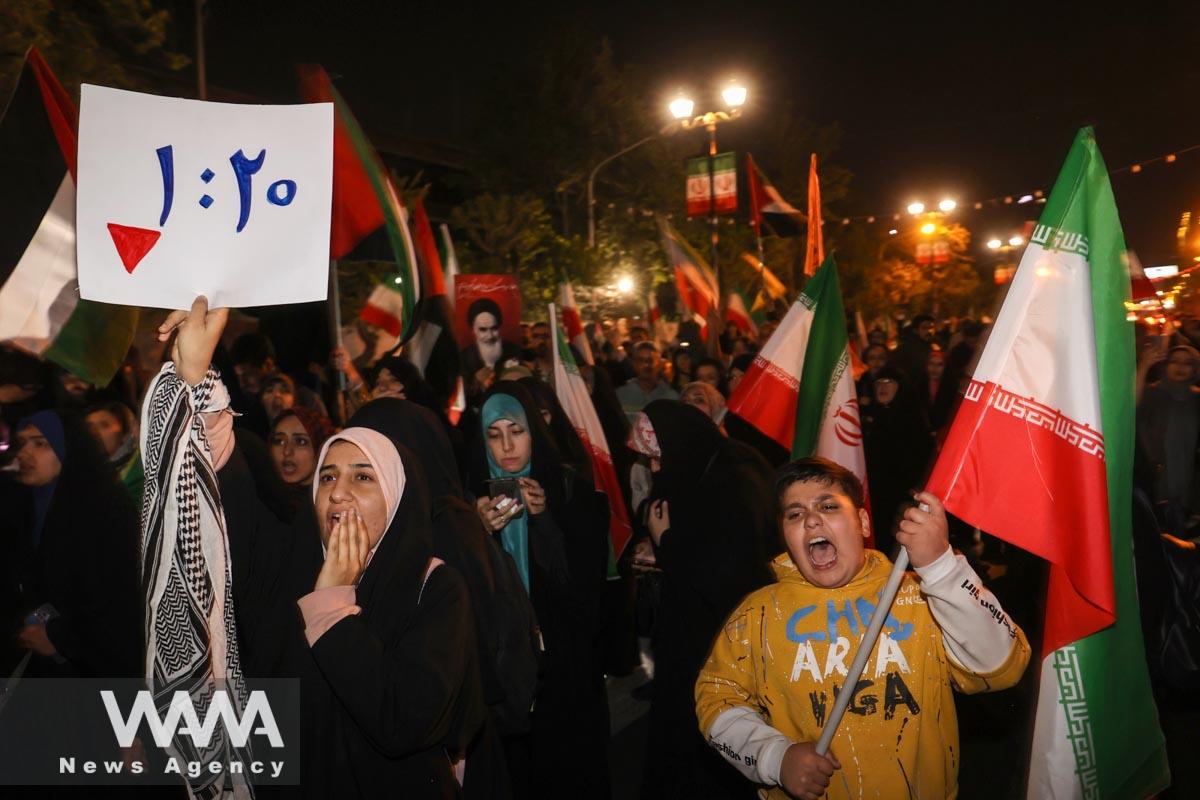 Iranian demonstrators chant after the IRGC attack on Israel, during an anti-Israeli gathering in front of the British Embassy