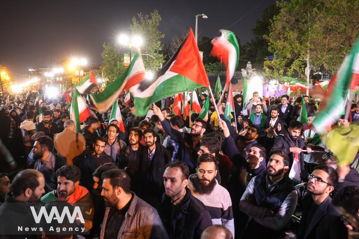 Iranian demonstrators chant after the IRGC attack on Israel, during an anti-Israeli gathering in front of the British Embassy