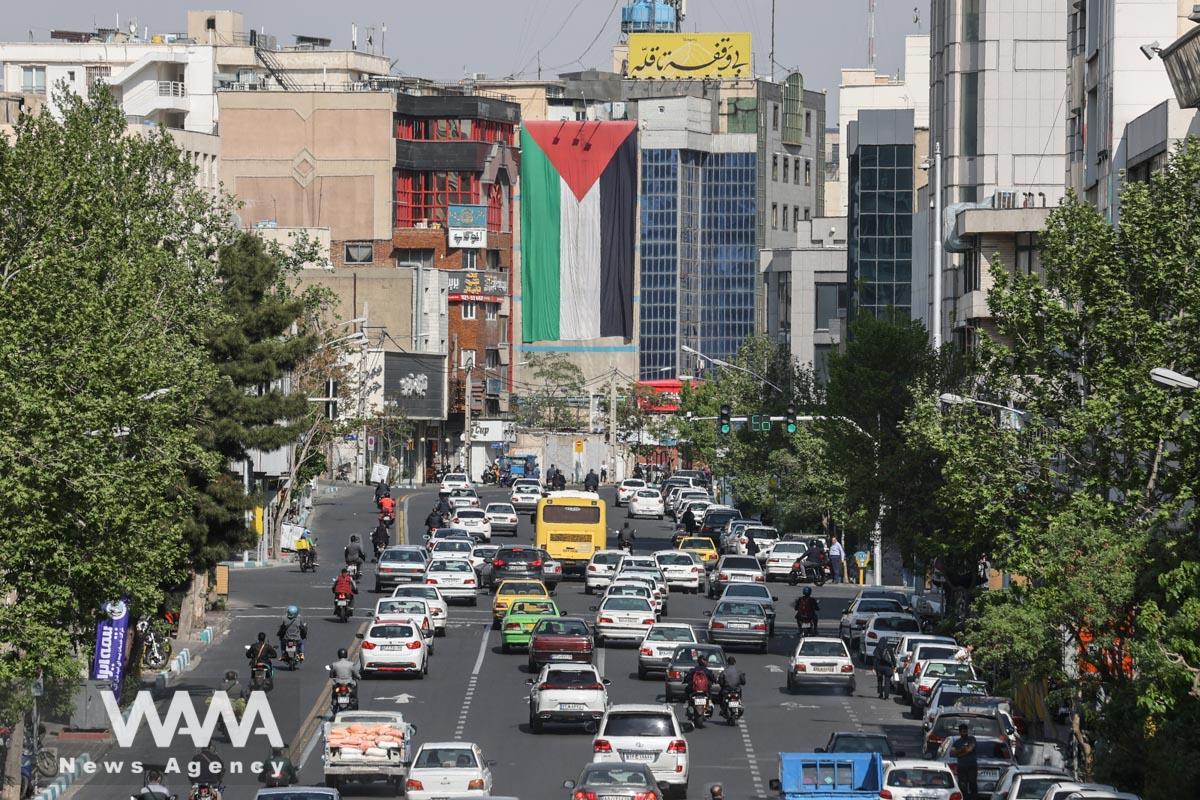 A huge Palestinian flag is seen on a building in a street in Tehran