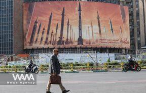 An anti-Israel billboard with a picture of Iranian missiles is seen in a street in Tehran