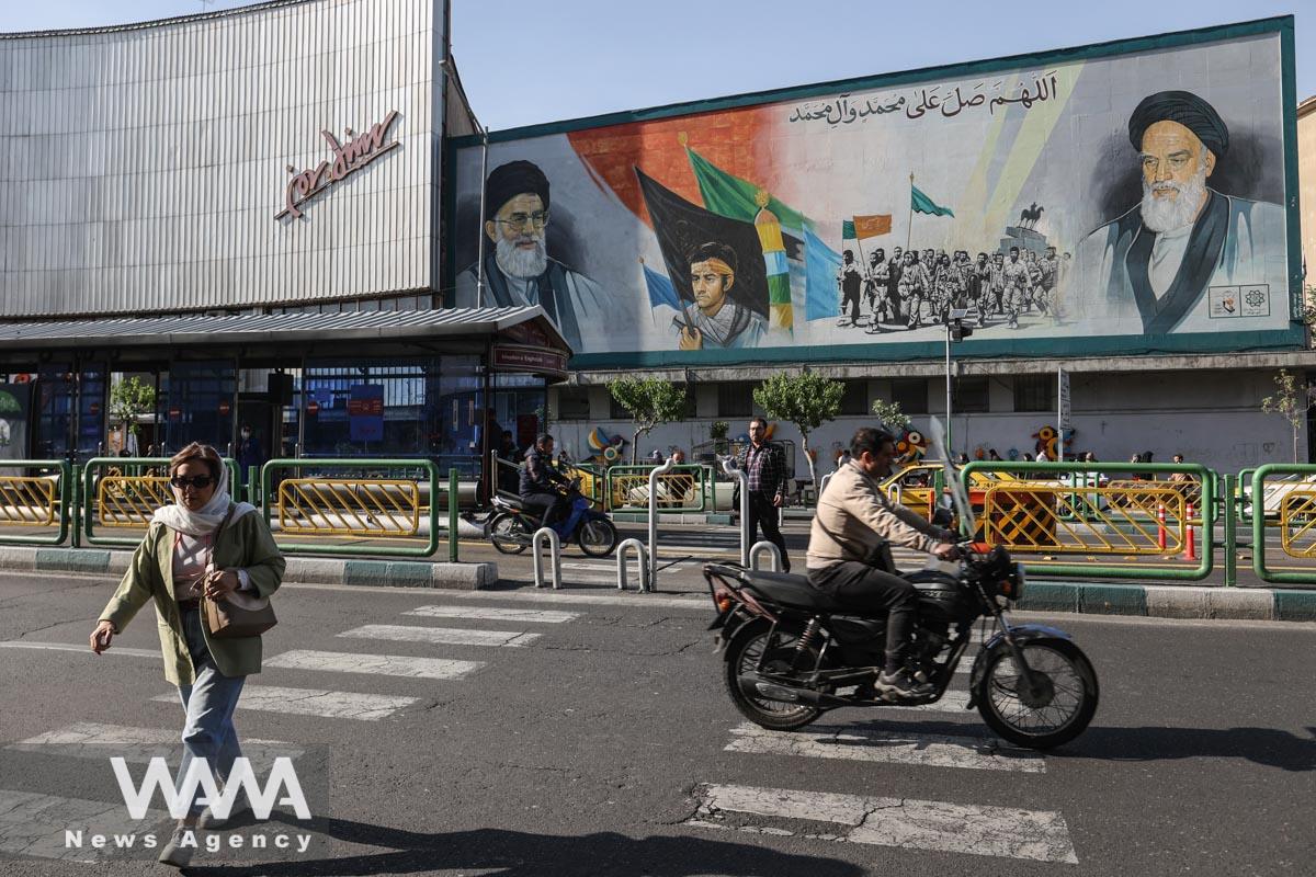 A mural depicting the late leader of the Islamic Revolution Ayatollah Ruhollah Khomeini and Iran's Supreme Leader Ayatollah Ali Khamenei are seen on a building in a street in Tehran