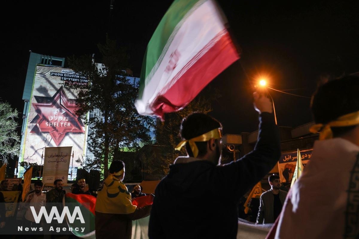 Iranians celebrate on a street, after the IRGC attack on Israel,