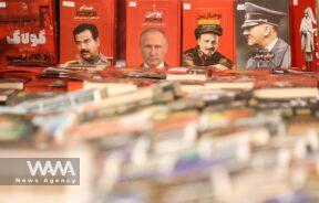 Books with photos of former Iraqi President Saddam Hussein, Russian President Vladimir Putin and Adolf Hitler on their cover are seen during the International Book Fair