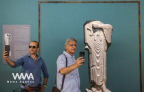 Iranian men take selfies at Iran's National Museum during World Museum Day
