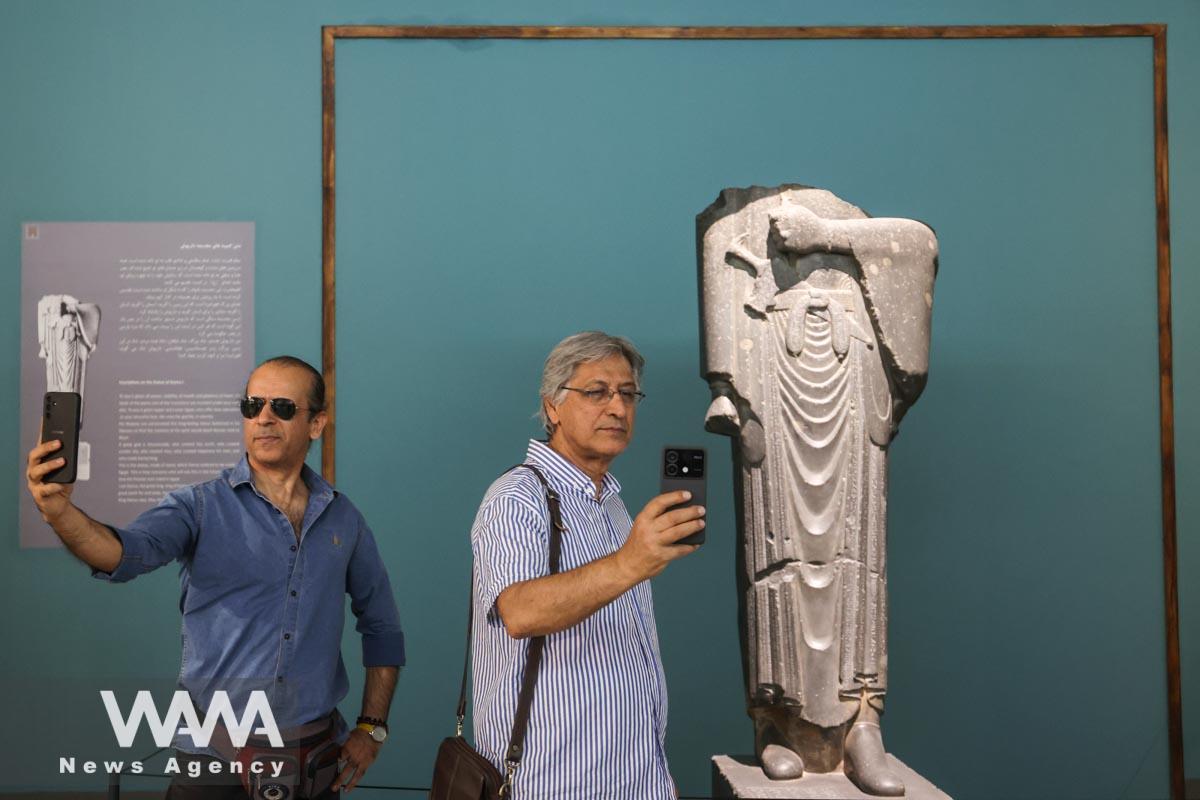 Iranian men take selfies at Iran's National Museum during World Museum Day