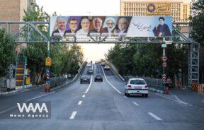 A billboard with a picture of the presidential candidates is displayed on a street