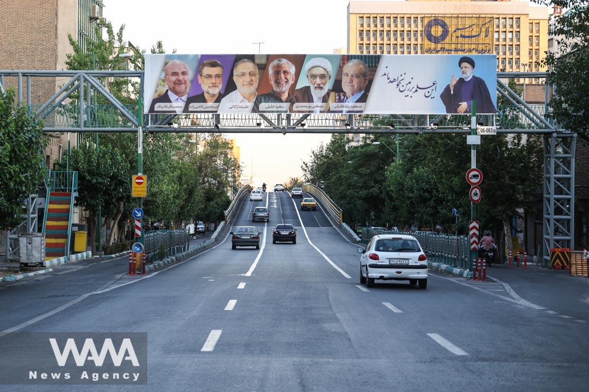 A billboard with a picture of the presidential candidates is displayed on a street