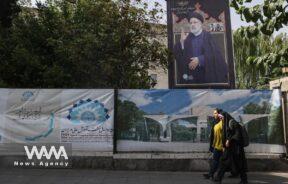 A banner with a picture of the late President Ebrahim Raisi is displayed on a street in Tehran