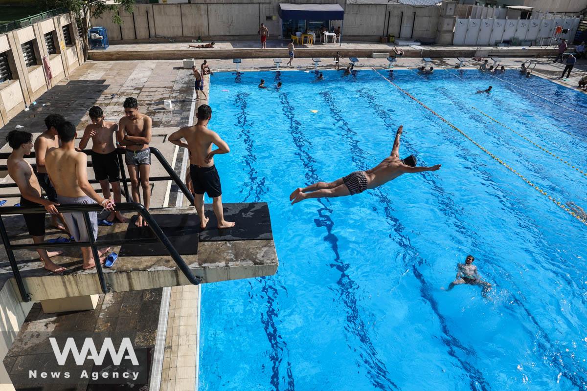 An Iranian man swims in a pool during the heat surge