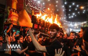 Iranian Shi'ite Muslims perform a torch procession during a mourning ritual ahead of Ashura, the holiest day on the Shi'ite Muslim calendar