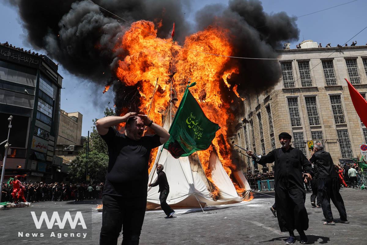 Iranian Shi'ite Muslims attend a ceremony to mark Ashura, the holiest day on the Shi'ite Muslim calendar,