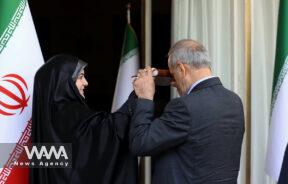 The endorsement ceremony of Iran's new president, Masoud Pezeshkian, The president's daughter holds the Quran over her father as he passes under it. - 28 July, 2024 -Tehran. Leader office / WANA News Agency