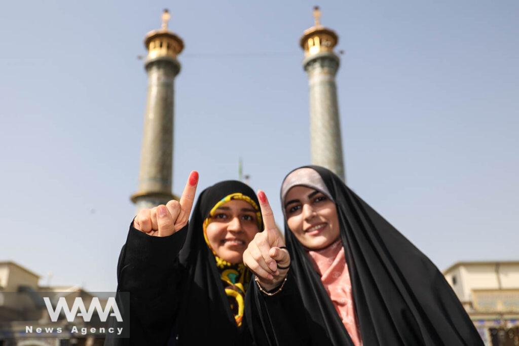 Women show their ink-stained fingers during the run-off presidential election between Masoud Pezeshkian and Saeed Jalili in Tehran