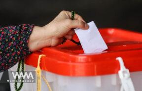 A voter drops a ballot into the ballot box in the run-off presidential election between Masoud Pezeshkian and Saeed Jalili in Tehran