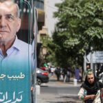 A banner of presidential candidate Masoud Pezeshkian is displayed in a street in Tehran