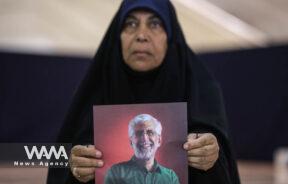A supporter holds a poster of Iranian presidential candidate Saeed Jalili during a campaign event in Tehran