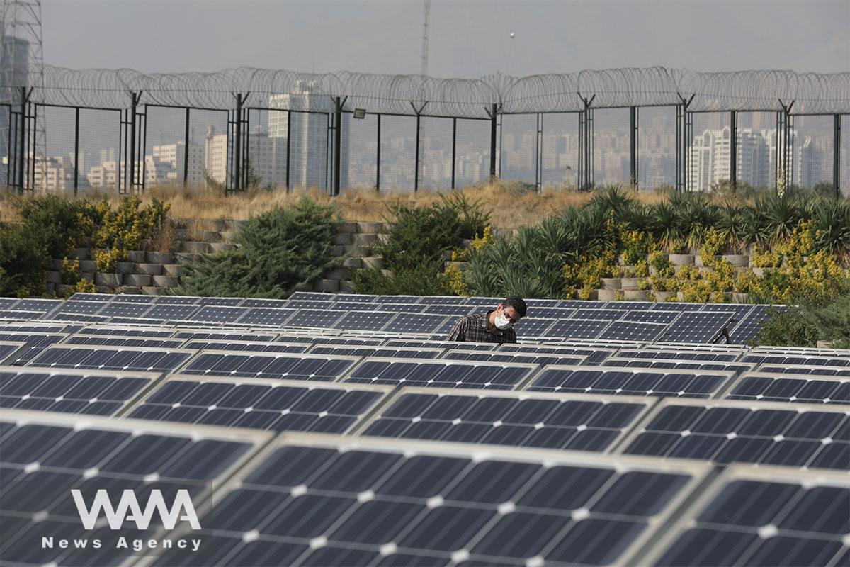 A technician checks solar panels in a powerhouse in Tehran, Iran October 11, 2020. Picture taken October 11, 2020. Majid Asgaripour/WANA (West Asia News Agency)