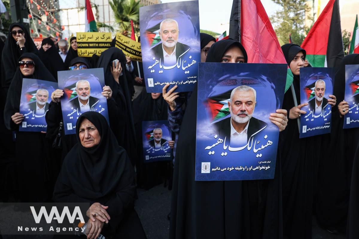 People hold posters of Palestinian group Hamas' top leader Ismail Haniyeh, during an anti-Israel gathering following the killing of him, amid the ongoing conflict between Israel and Hamas, in Tehran, Iran July 31, 2024. Majid Asgaripour/WANA (West Asia News Agency)