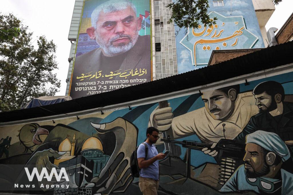 A billboard with a picture of newly appointed Hamas leader Yahya Sinwar is displayed on a building in a street