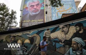 A billboard with a picture of newly appointed Hamas leader Yahya Sinwar is displayed on a building in a street